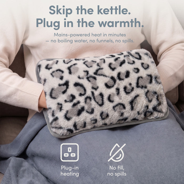 Animal Print rechargeable hot water bottle on lap, plug-in heat with no fill or spills