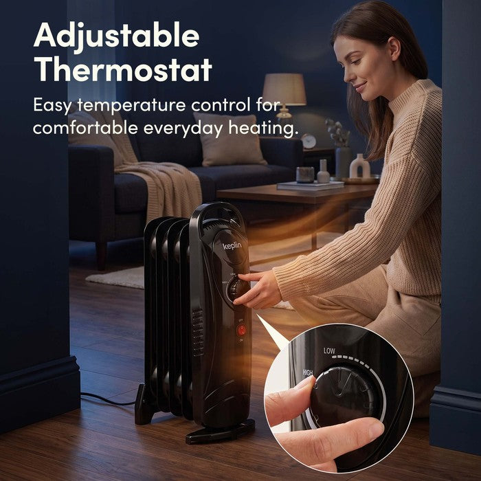 Adjustable thermostat dial on black oil filled radiator for easy temperature control