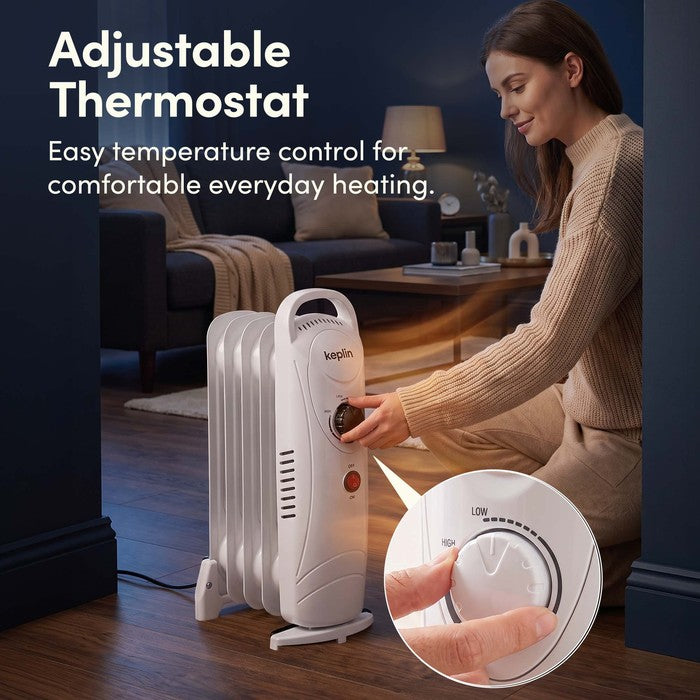 Adjustable thermostat dial on white oil filled radiator for easy temperature control