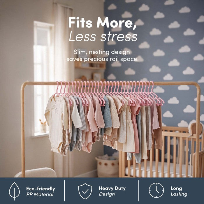 Pink nursery hangers holding a full rail of baby clothes to save rail space