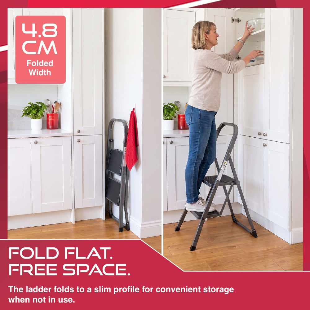 Haltons 2 step ladder folded to 4.8cm wide beside kitchen cupboards and in use at a wall cabinet