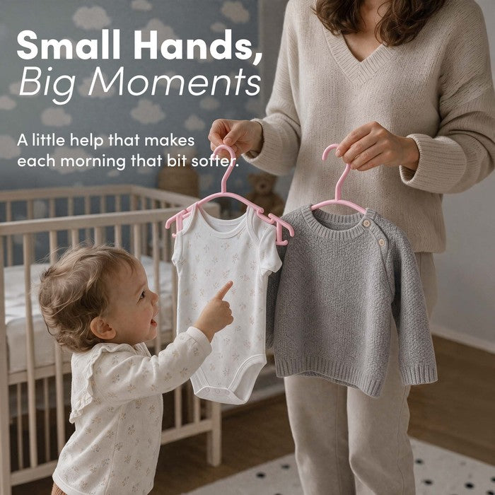 Mother and toddler holding pink nursery hangers with baby clothes at home