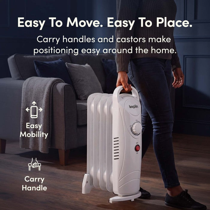 Carrying white oil filled radiator by handle with castors for easy mobility