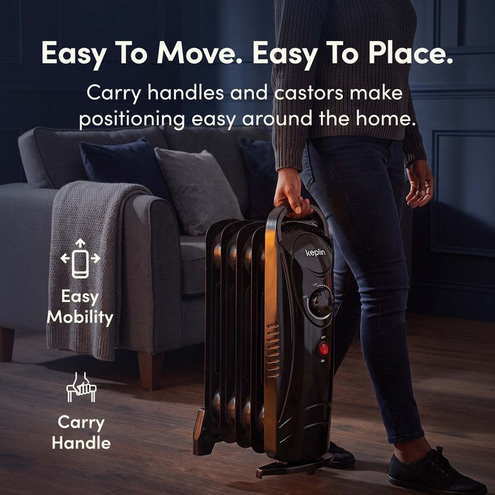 Carrying black oil filled radiator by handle with castors for easy mobility
