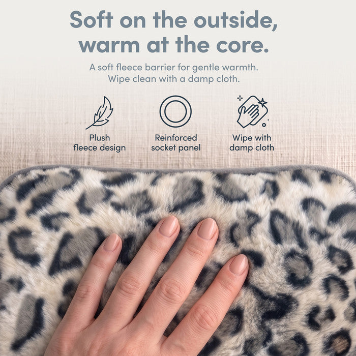 Hand on plush Animal Print fleece cover of electric hot water bottle, wipe clean