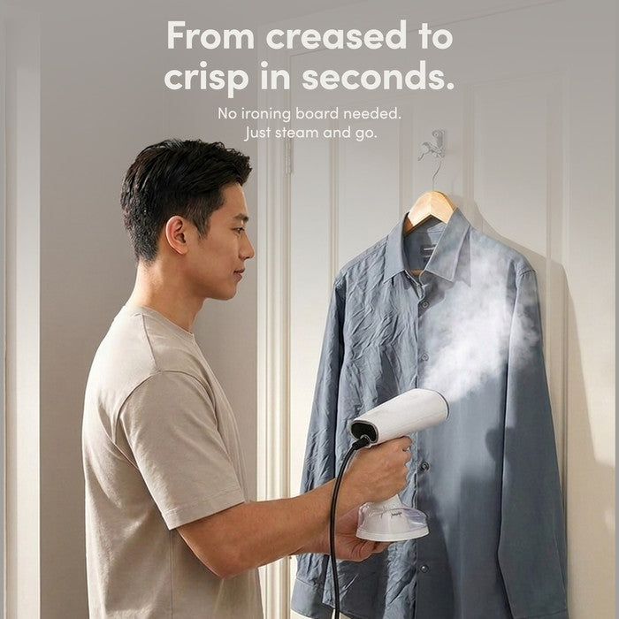 Man Using Handheld Clothes Steamer on Shirt No Ironing Board Needed