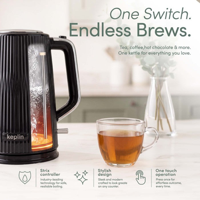 Close-up of a black ribbed Keplin electric kettle with water boiling inside, beside a glass cup of tea, illustrating the Strix controller and one-touch operation.