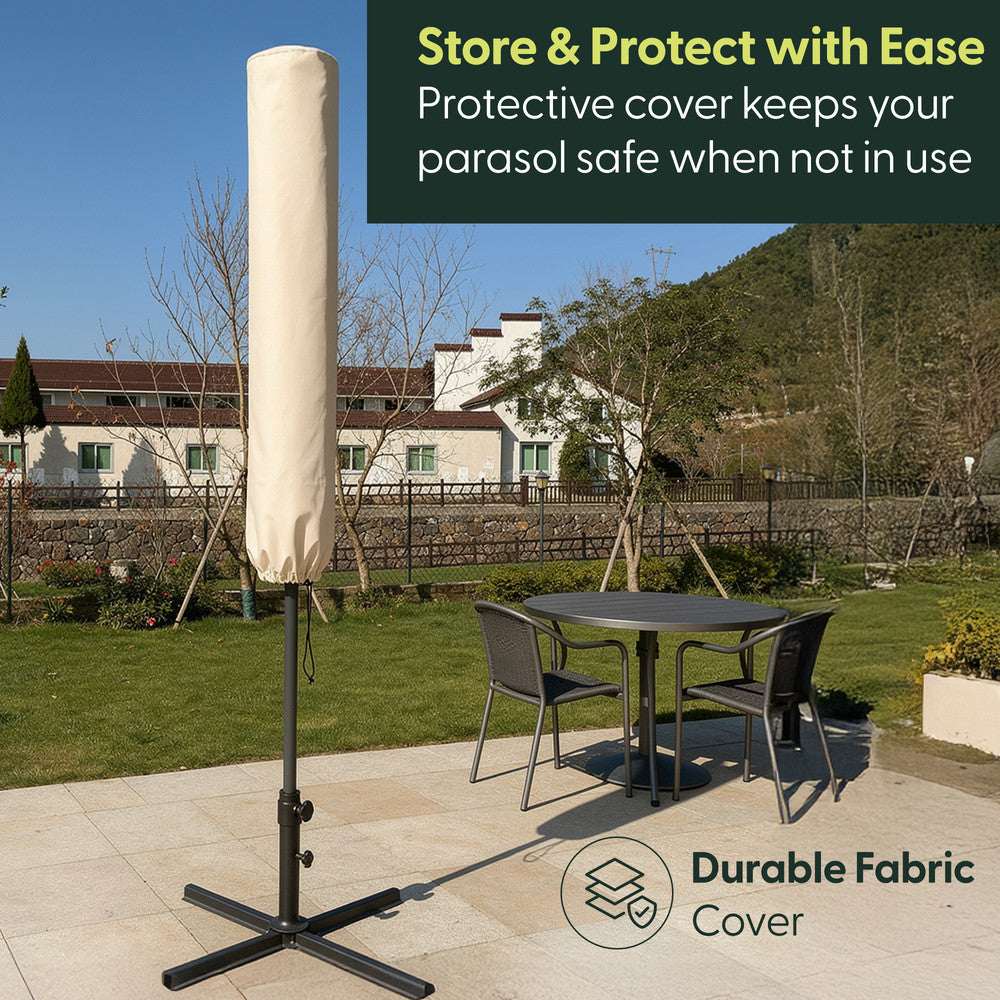 Cream cantilever garden parasol stored in matching protective fabric cover on cross base – weatherproof storage when not in use