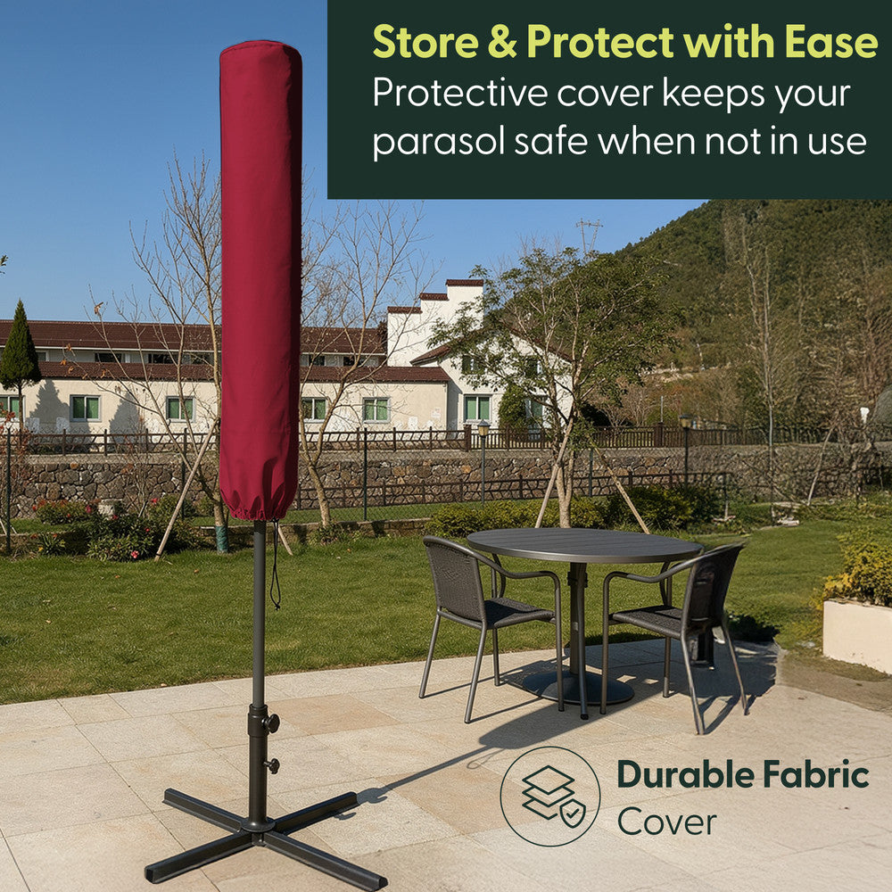 Burgundy cantilever garden parasol stored in matching protective fabric cover on cross base – weatherproof storage when not in use