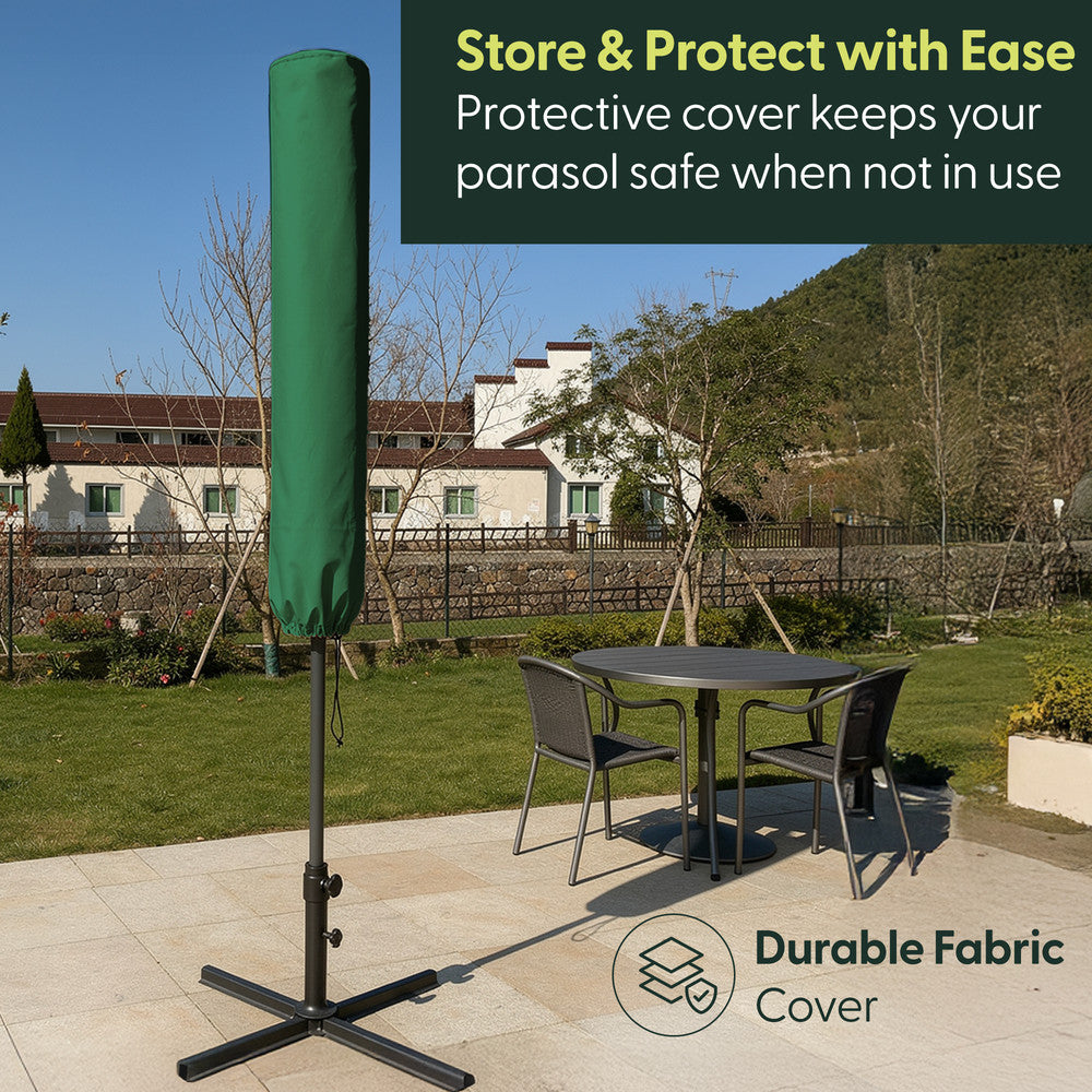 Green cantilever garden parasol stored in durable fabric protective cover on cross base in garden setting – weatherproof storage when not in use