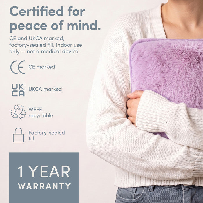 Lilac electric hot water bottle held close, CE and UKCA marked with 1 year warranty