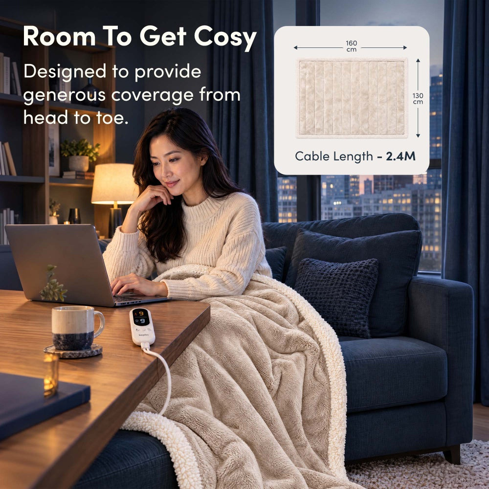 Woman on laptop under cream electric throw, 160 x 130cm size with 2.4m cable