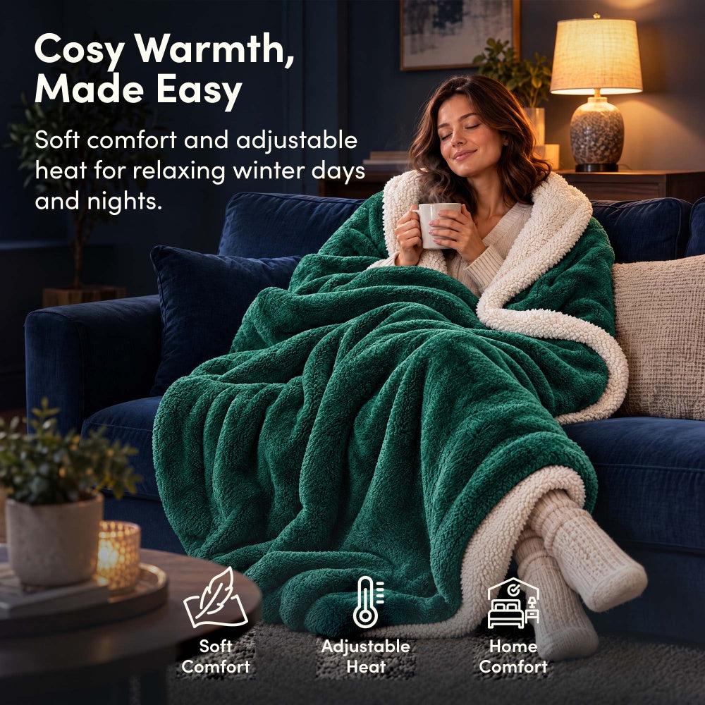 Woman relaxing on sofa under emerald green electric heated throw blanket with sherpa lining