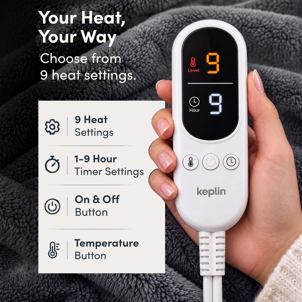 Hand holding remote on charcoal grey electric throw, 9 heat settings, 1-9 hour timer