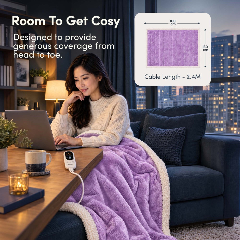 Woman on laptop under lilac purple electric throw, 160 x 130cm size with 2.4m cable