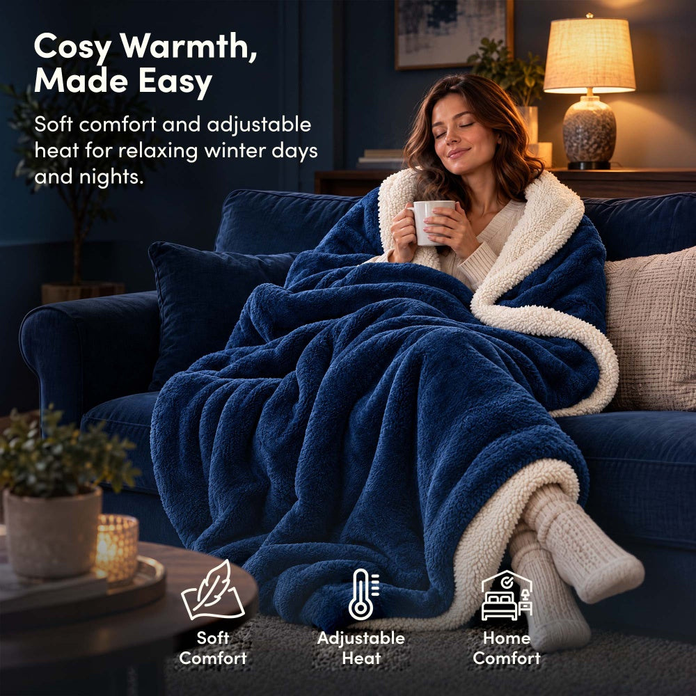Woman relaxing on sofa under navy blue electric heated throw blanket with sherpa lining