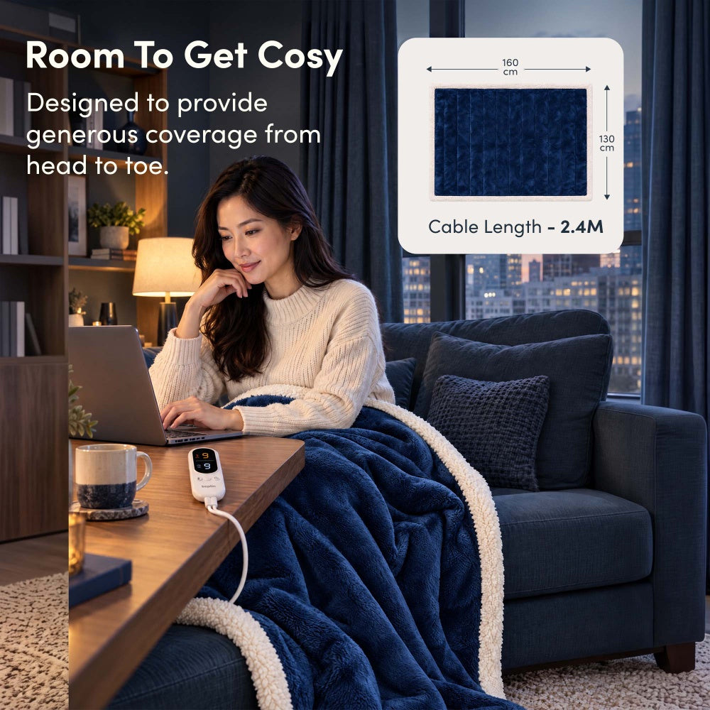 Woman on laptop under navy blue electric throw, 160 x 130cm size with 2.4m cable