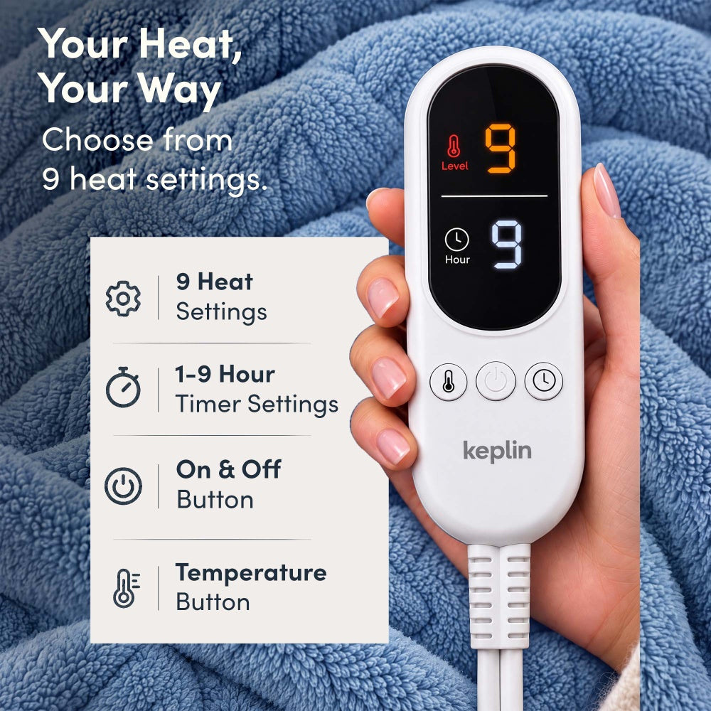 Hand holding remote on blue jacquard electric throw, 9 heat settings, 1-9 hour timer
