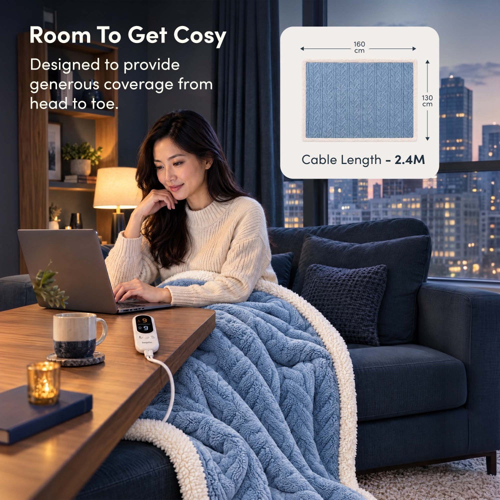 Woman on laptop under blue jacquard electric throw, 160 x 130cm size with 2.4m cable