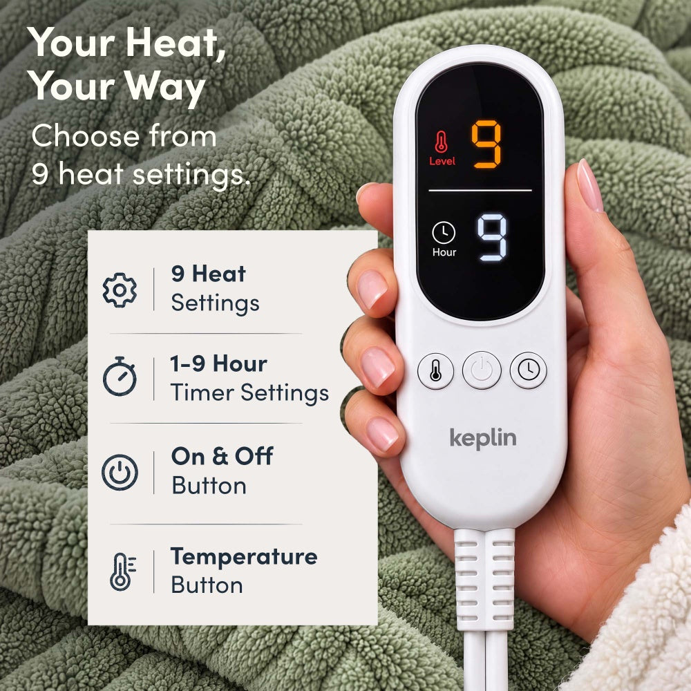 Hand holding remote on sage green jacquard electric throw, 9 heat settings, 1-9 hour timer