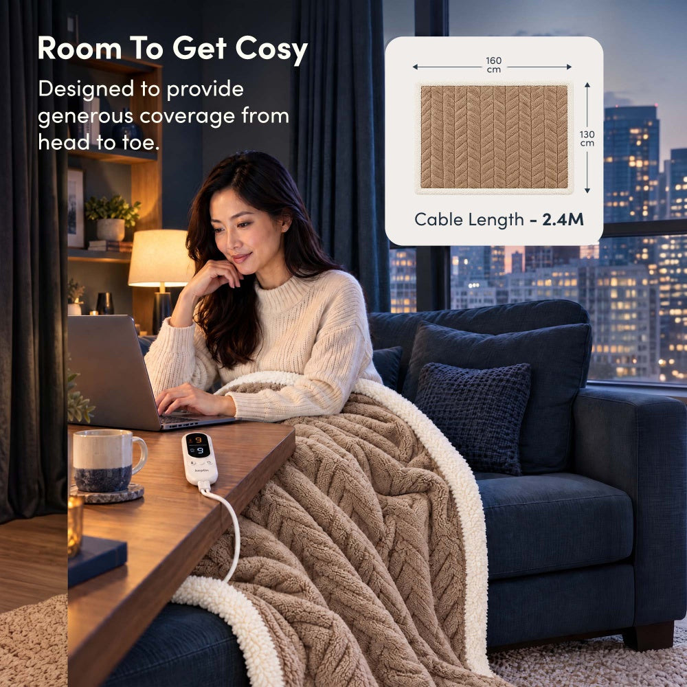 Woman on laptop under taupe jacquard electric throw, 160 x 130cm size with 2.4m cable