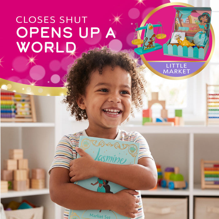 Smiling toddler hugging the Disney Princess Jasmine market set storybook box