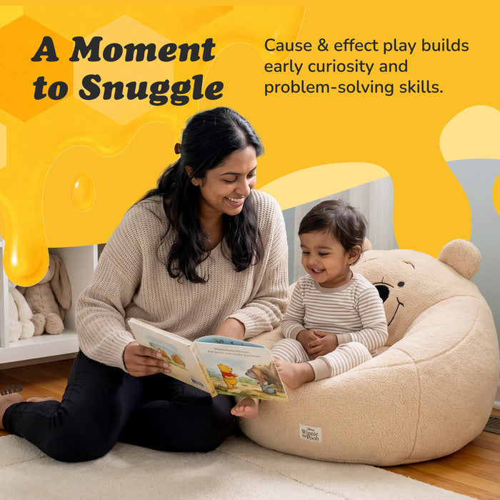 Mother reading a book to a child sitting in the Winnie the Pooh plush snuggle chair