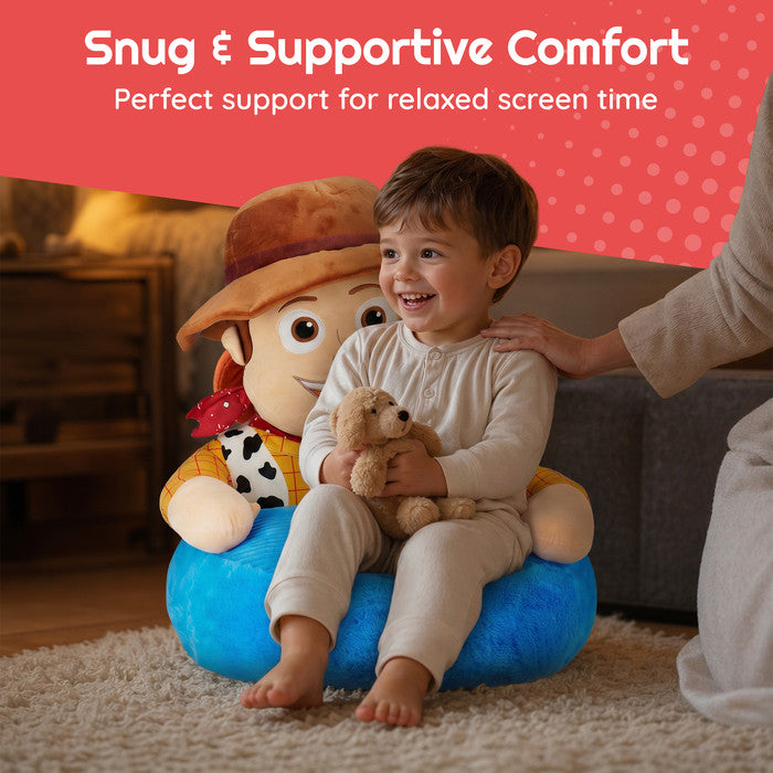 Young boy sitting in Toy Story Woody plush floor chair holding teddy – snug and supportive kids sofa chair