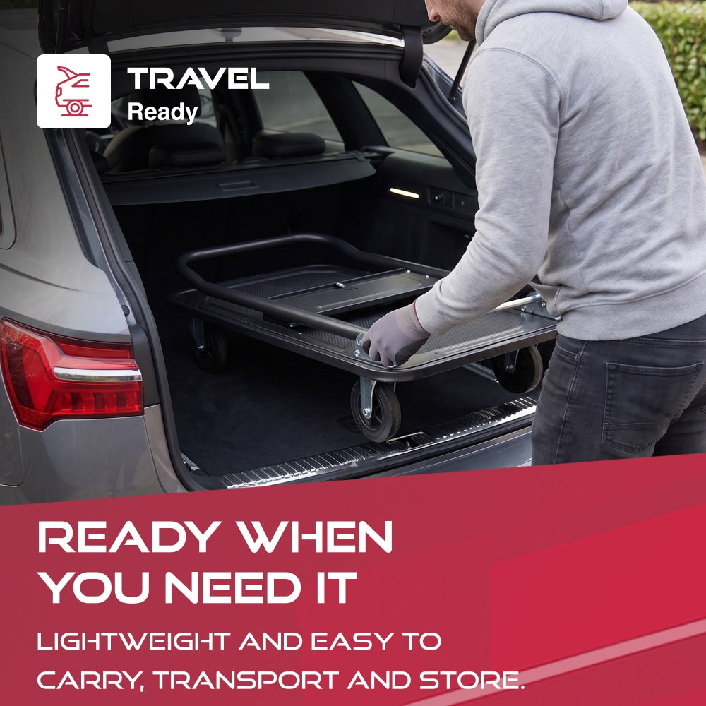 Man placing the folded Haltons platform trolley into a car boot with a Travel Ready badge