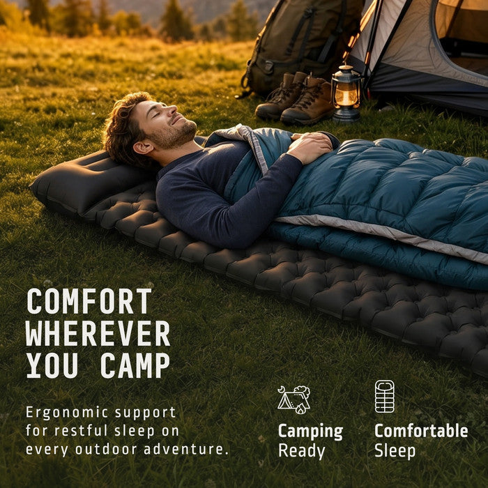Man sleeping on Voyager black inflatable camping mat outdoors near tent
