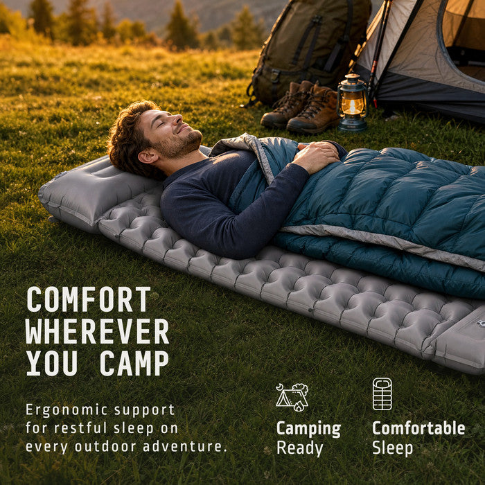 Man sleeping on Voyager grey inflatable camping mat outdoors near tent
