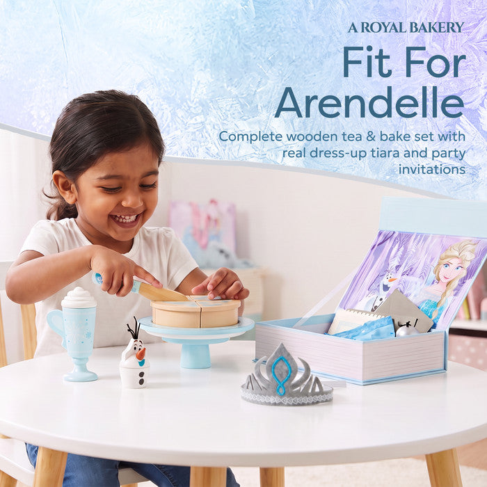 Child playing with Disney Frozen Elsa wooden tea party set and pretend cake 