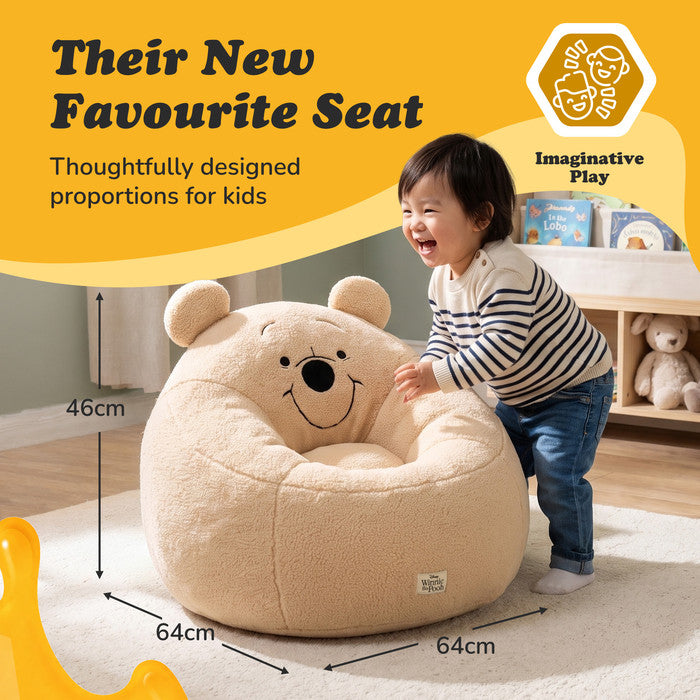 Toddler playing with the Winnie the Pooh snuggle chair, showing 46 x 64 x 64cm dimensions