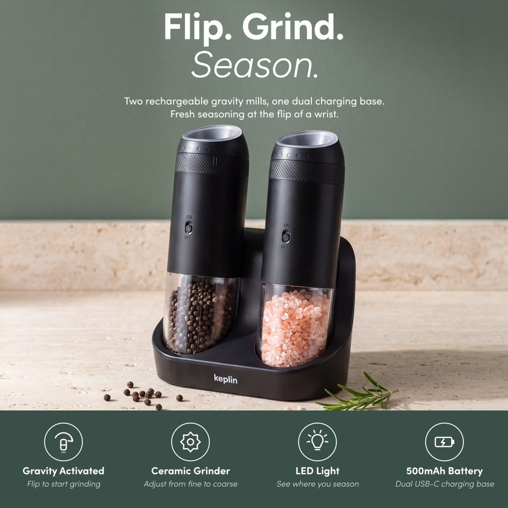 Two black gravity mills on their dual base with gravity activated and ceramic grinder and LED icons