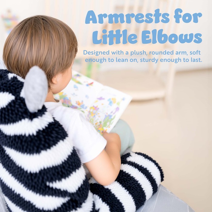 Close-up of a child resting on the padded armrest of a Bluey plush sofa chair