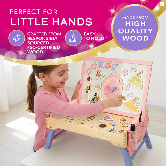 Girl placing magnetic pieces on the FSC-certified wooden Disney Princess creation station 