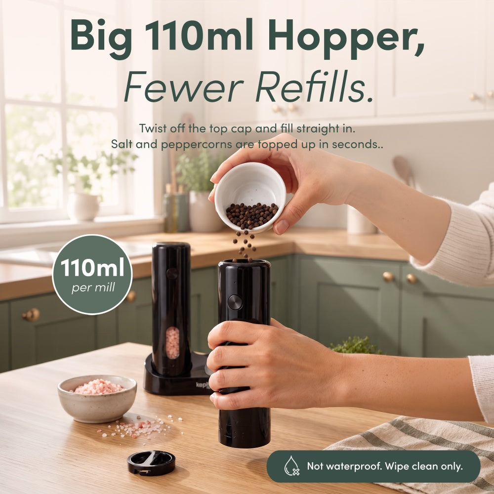 Refilling the 110ml hopper of a black rechargeable mill with peppercorns after twisting off the top cap