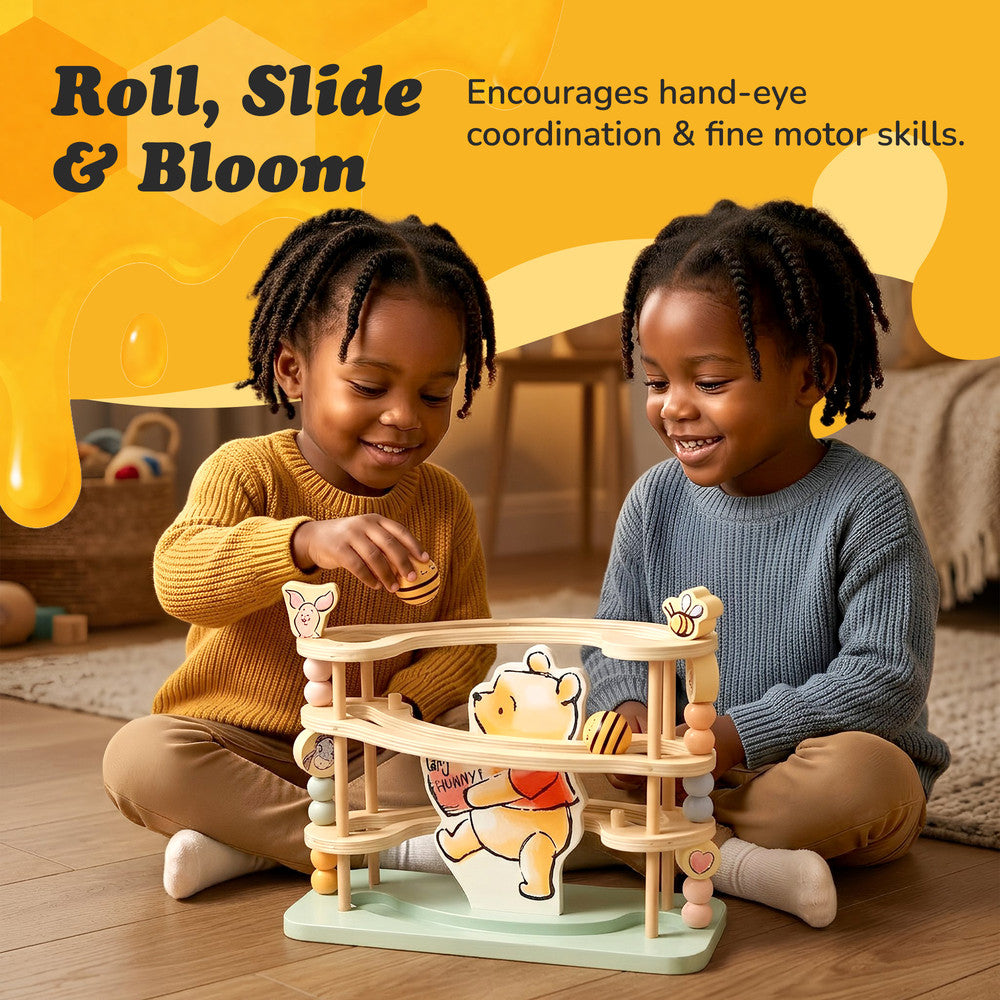 Toddler playing with Disney Winnie the Pooh wooden ball run track
