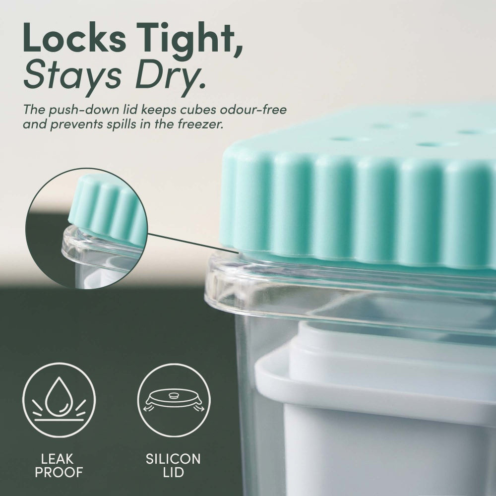 Close-up of the push-down teal silicone lid sealing the clear ice bin
