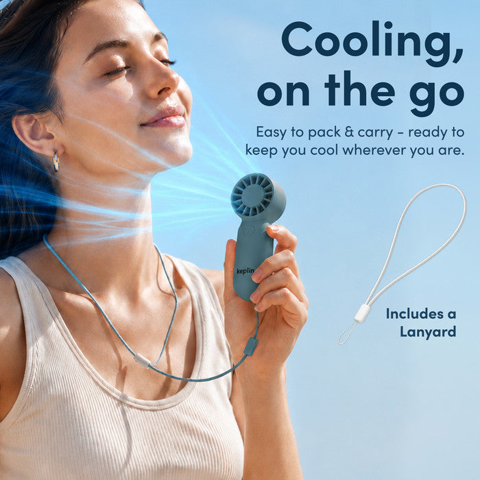 Woman cooling face with KEPLIN mini personal fan on neck lanyard strap – portable fan for summer