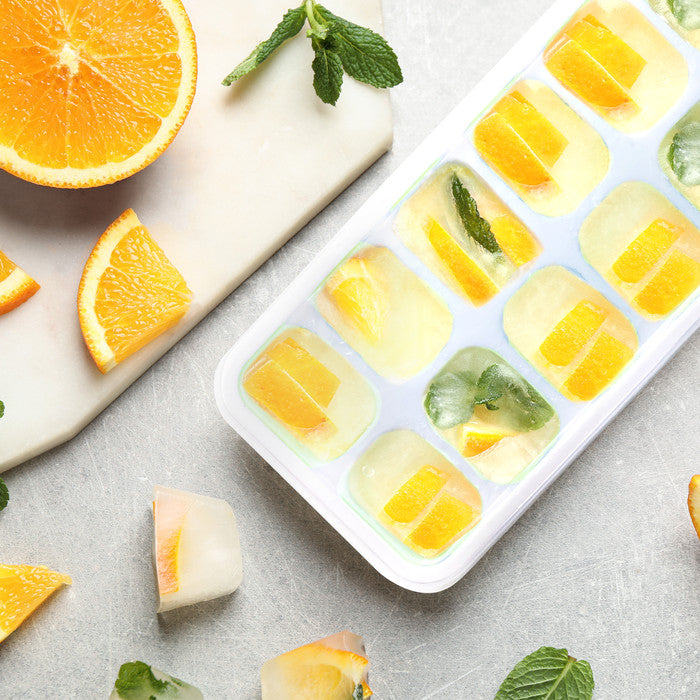 Keplin silicone ice cube tray filled with orange slices and fresh mint leaves, ideal for flavoured ice cubes and cocktails