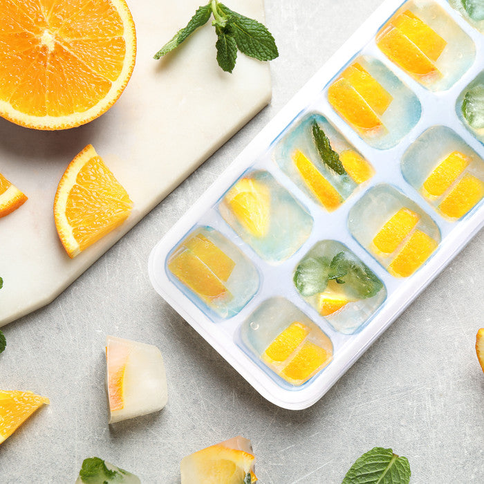 Keplin silicone ice cube tray filled with orange slices and fresh mint leaves, ideal for flavoured ice cubes and cocktails