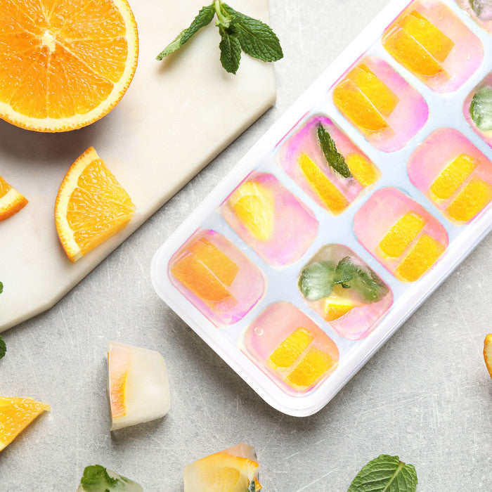 Keplin silicone ice cube tray filled with orange slices and fresh mint leaves, ideal for flavoured ice cubes and cocktails