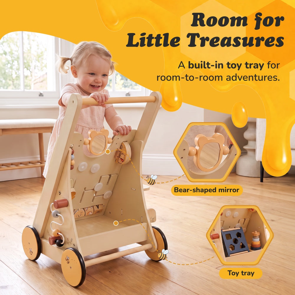 Toddler pushing the Winnie the Pooh wooden walker with built-in toy tray and bear-shaped mirror