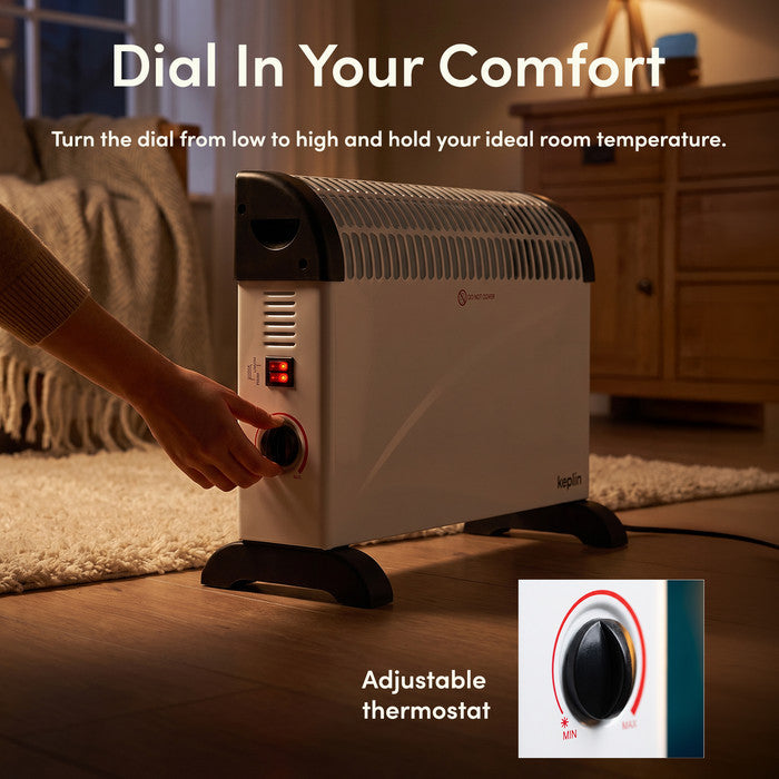 Adjusting thermostat dial on white convector heater from min to max