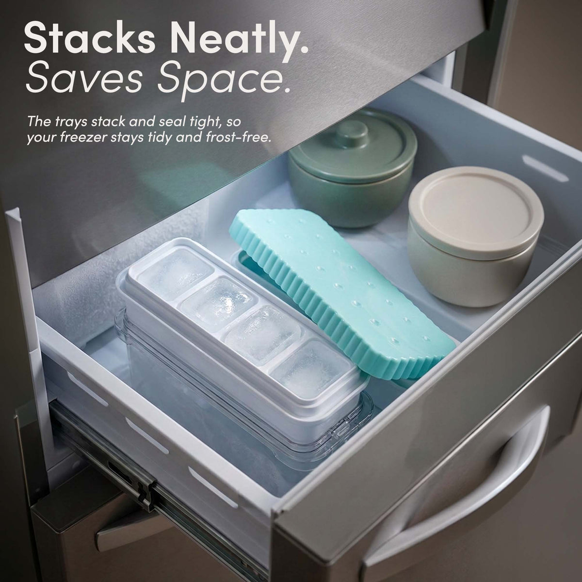 Stackable ice cube tray with lid and bin in a freezer drawer