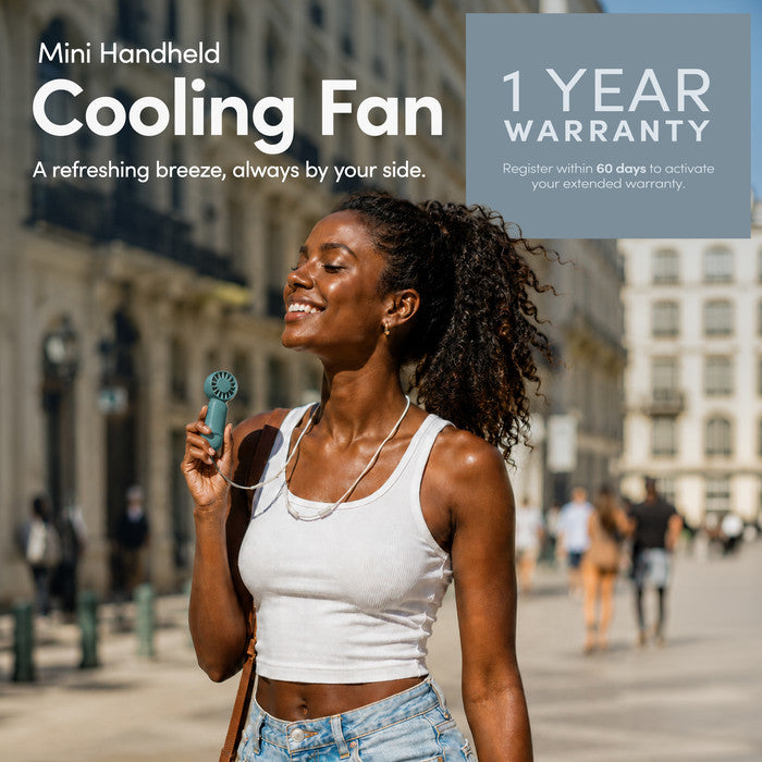 Woman using KEPLIN mini handheld cooling fan outdoors – portable personal fan with 1 year warranty