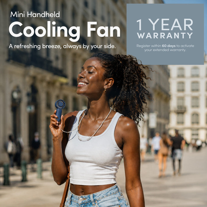 Woman using KEPLIN mini handheld cooling fan outdoors – portable personal fan with 1 year warranty