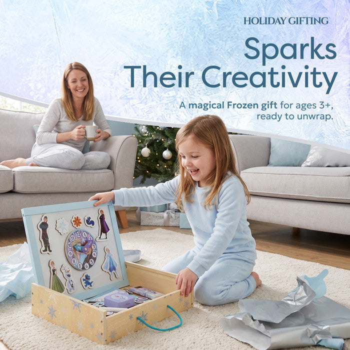 Girl unwrapping Disney Frozen Creation Station at Christmas - gifts for 3 year old girl