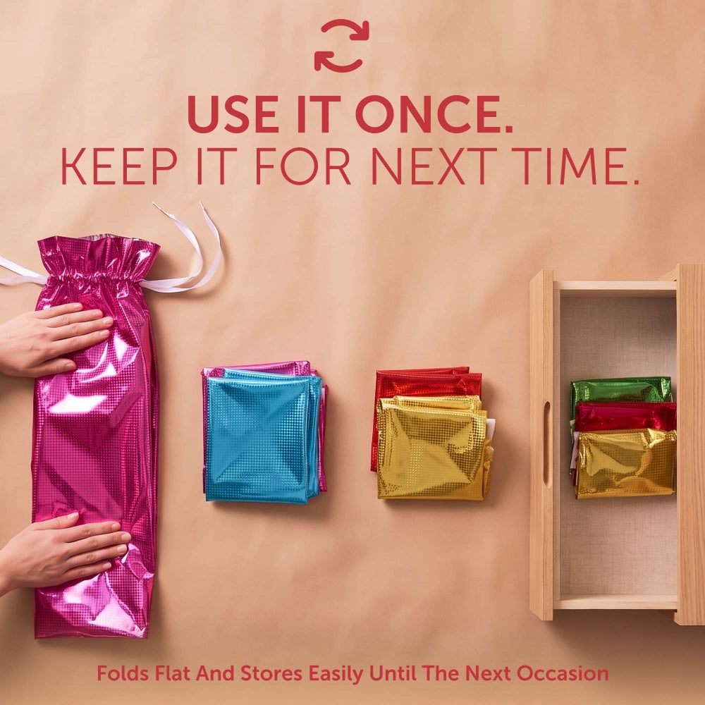 Plain foil gift bags folded flat and stored in a drawer, reusable for every occasion